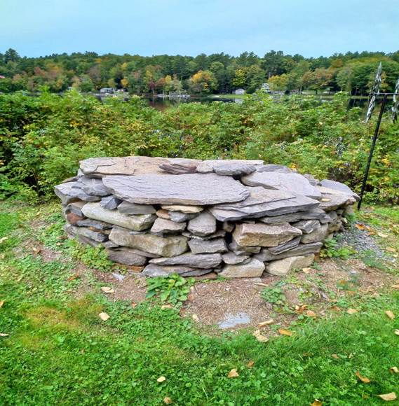 A pile of rocks in a grassy area

Description automatically generated