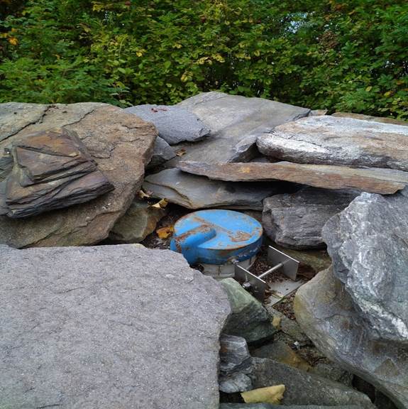 A pile of rocks and a blue object

Description automatically generated