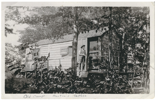 A person standing in front of a house

Description automatically generated