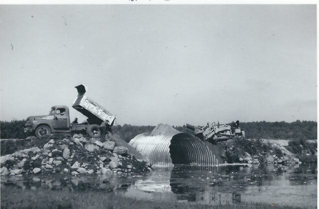 A truck driving through a tunnel

Description automatically generated